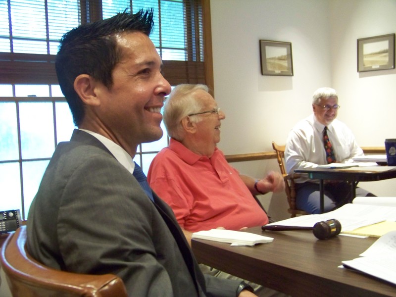 Henlopen Acres Town Solicitor Glenn Mandalas, foreground, Mayor David Hill, center, and Town Manager Tom Roth, share a laugh at the July 12 commissioners meeting. The town commissioners are optimistic a resolution will be found to an ongoing zoning dispute with the Rehoboth Art League. BY RYAN MAVITY